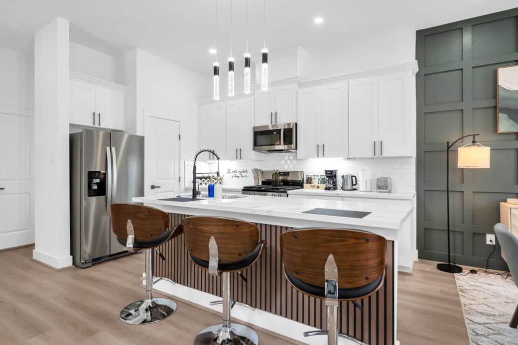 The spacious island offers plenty of room for prepping snacks or sharing breakfast together, with three comfy bar stools ideal for casual dining. The spacious island offers plenty of room for prepping snacks or sharing breakfast together, with three comfy bar stools ideal for casual dining.