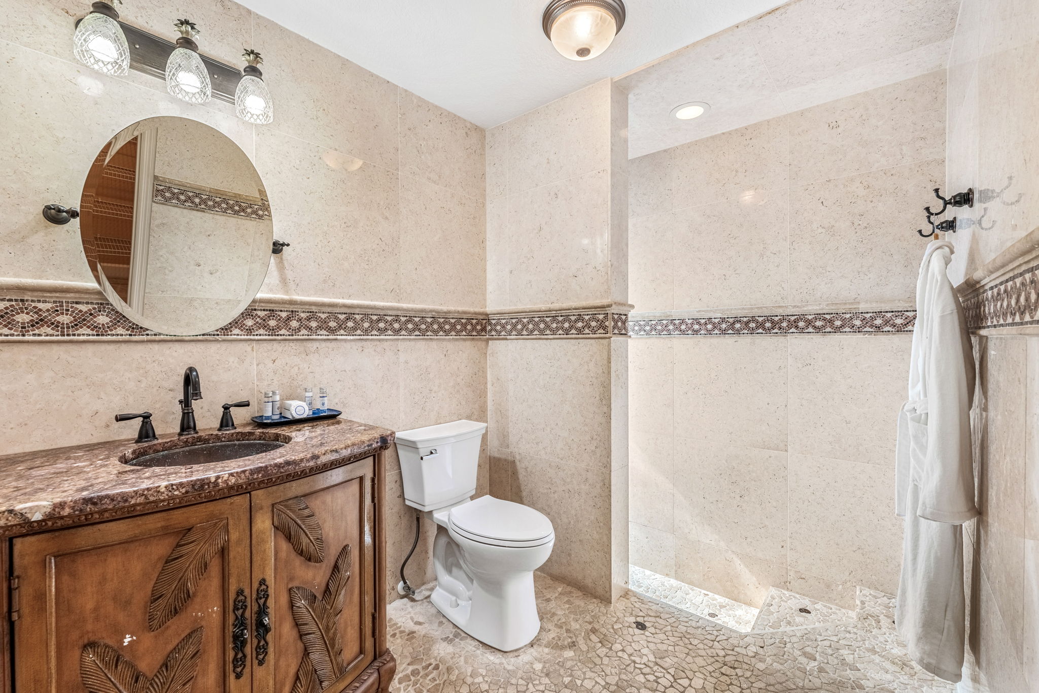 Full bathroom 2, featuring a spacious shower and a beautiful vanity.