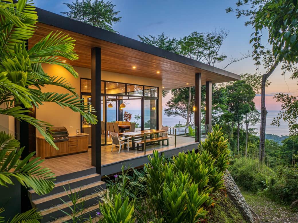 Casa Cosara Grande exterior view with infinity pool and exuberant sunset and ocean backgroung.   