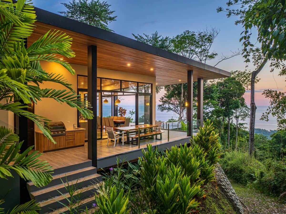 Casa Cosara Grande exterior view with infinity pool and exuberant sunset and ocean backgroung.   