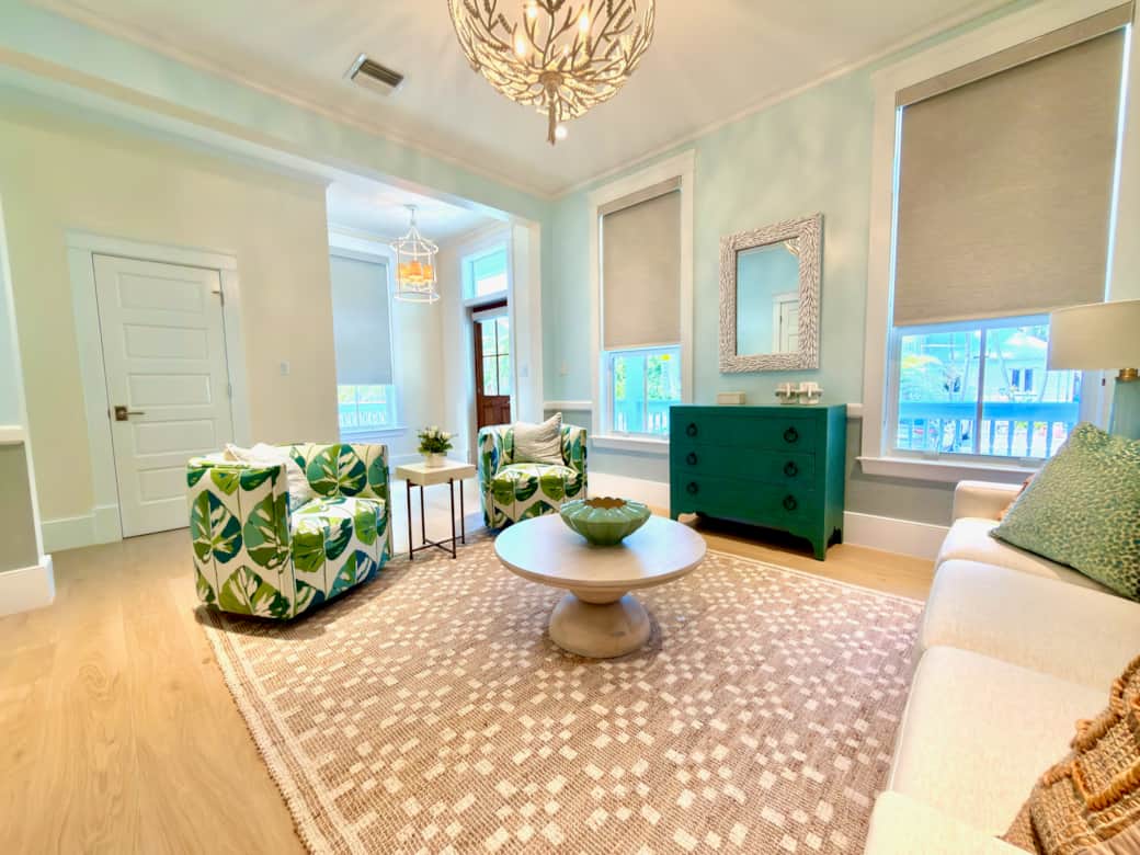 Bright living room near the entry with elegant coastal-modern style and cozy seating.