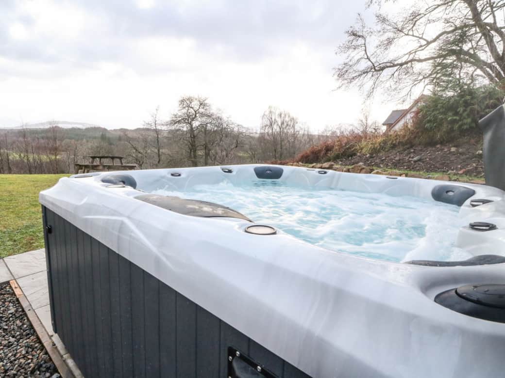 Soak in the hot tub whilst enjoying mountain views