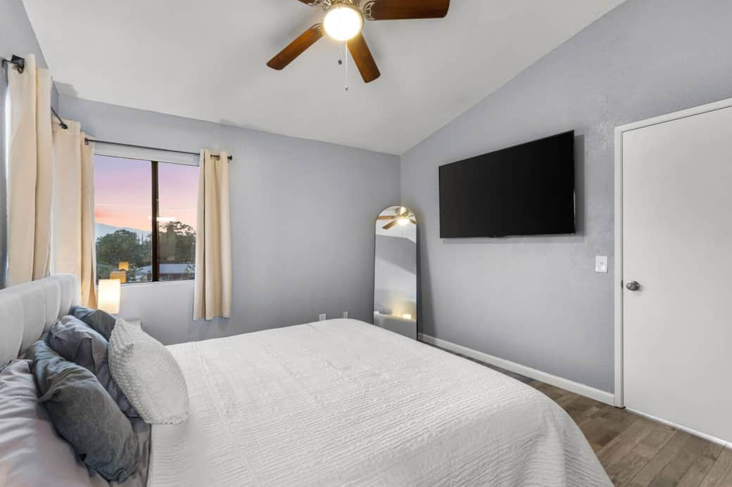 Unwind in bed with your favorite shows on the wall-mounted smart TV—comfort at your fingertips.