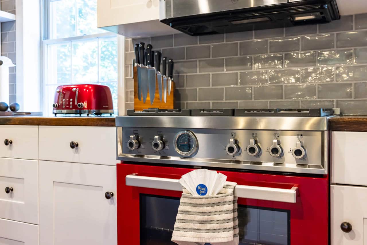 Close-up of the red Bertazzoni range and stainless steel controls