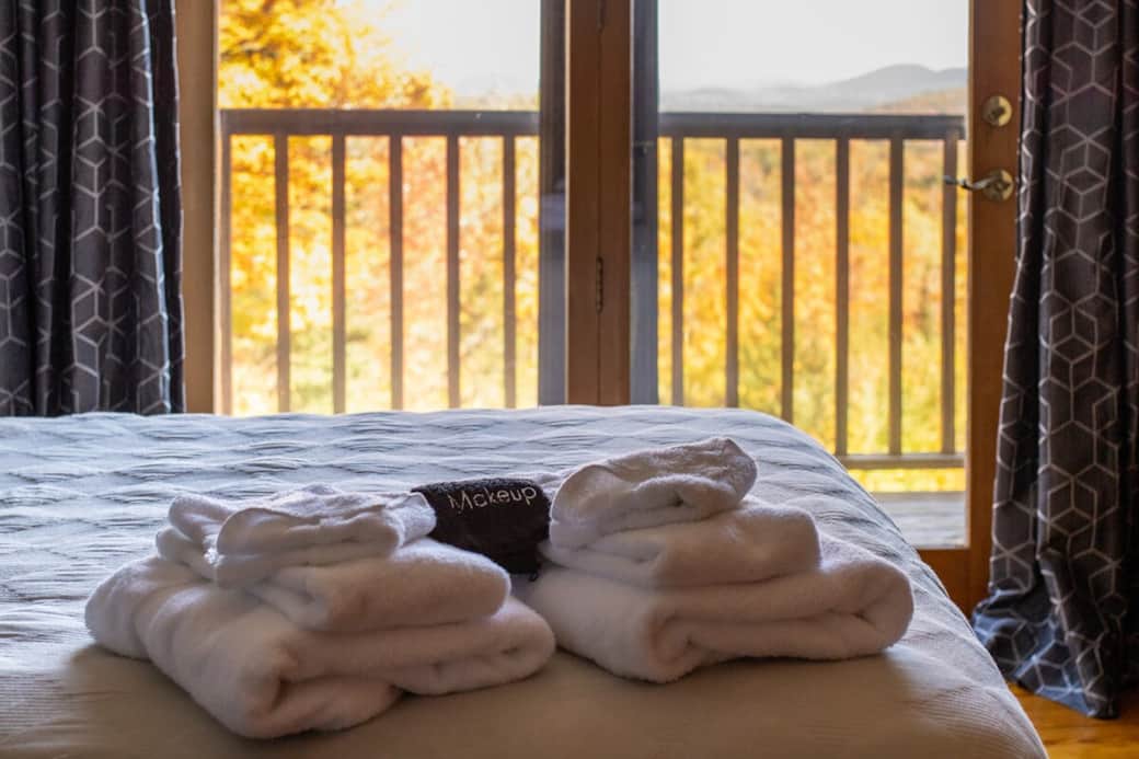Bedroom Retreat: Plush towels await as you soak in stunning mountain views from your private balcony!