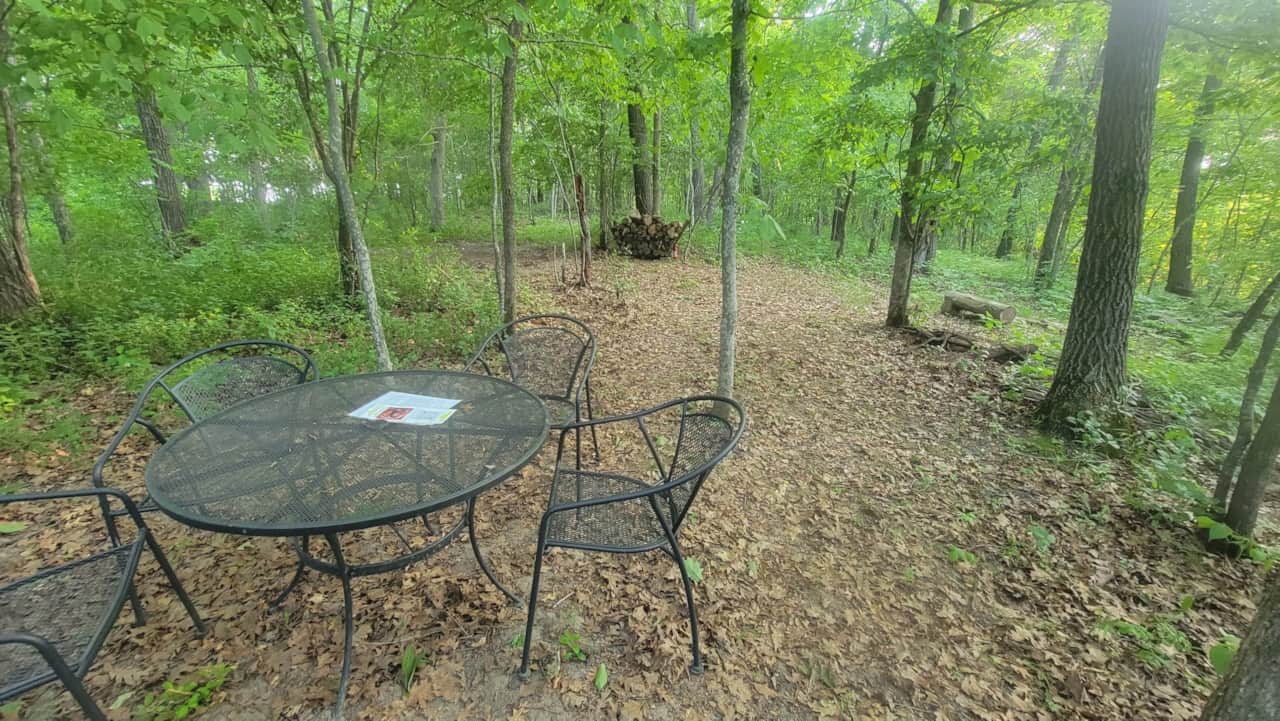 Table and chairs facing the rest of the campsite