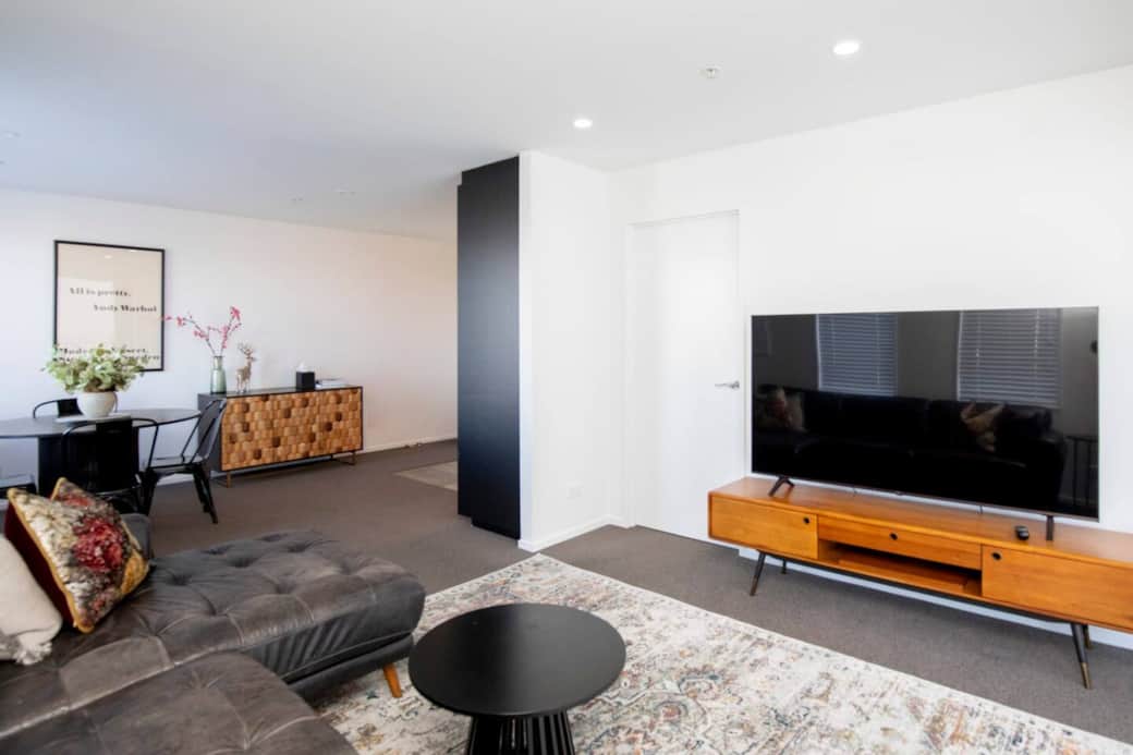 Large living with 60" TV and lush couch