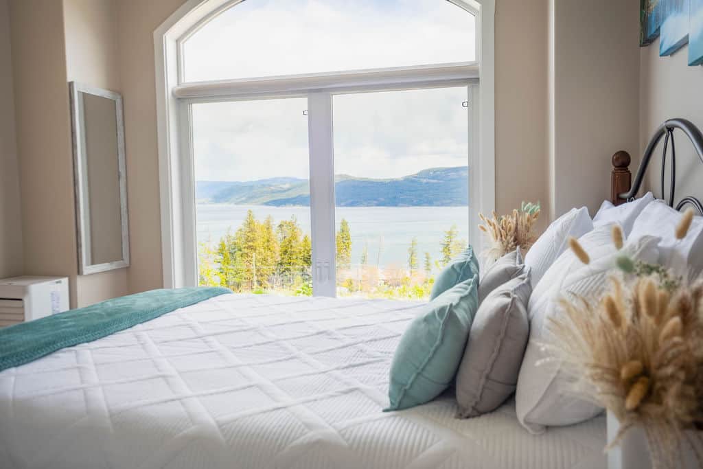 Bedside View with Lake Scenery and Soft Coastal Decor