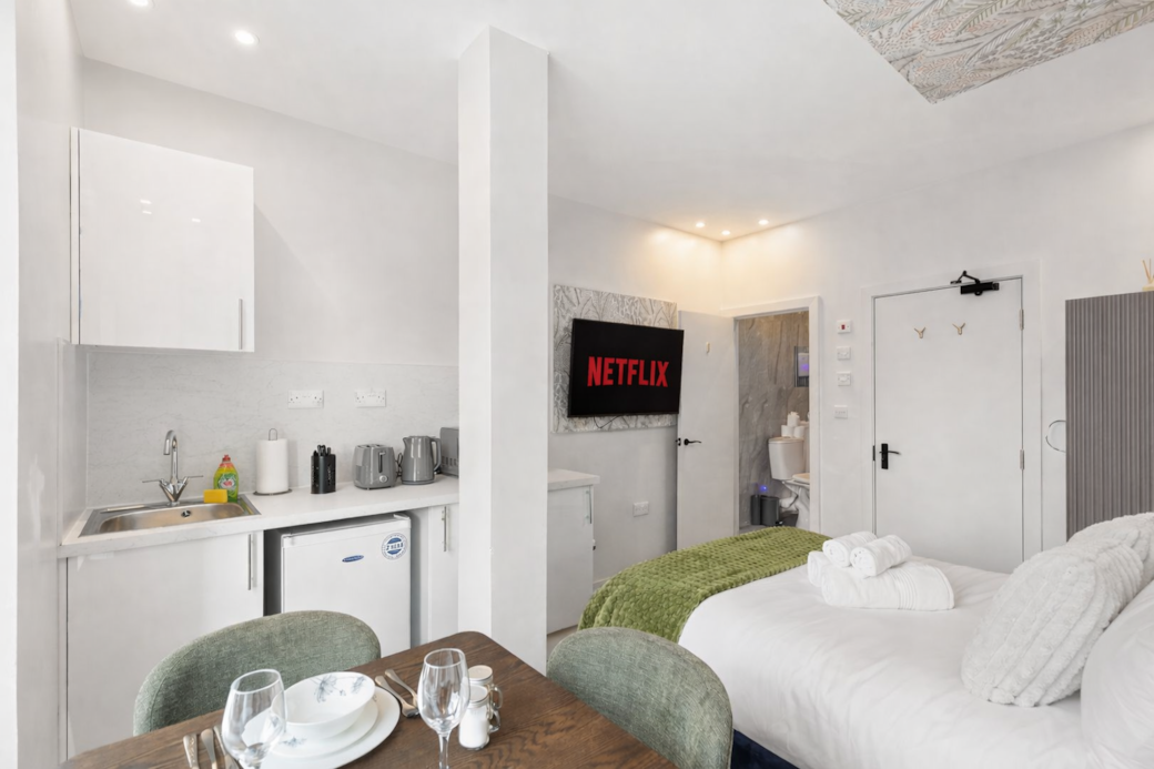 A stylish open-plan space combining a modern kitchenette, dining area and luxurious double bed. A stylish open-plan space combining a modern kitchenette, dining area and luxurious double bed.