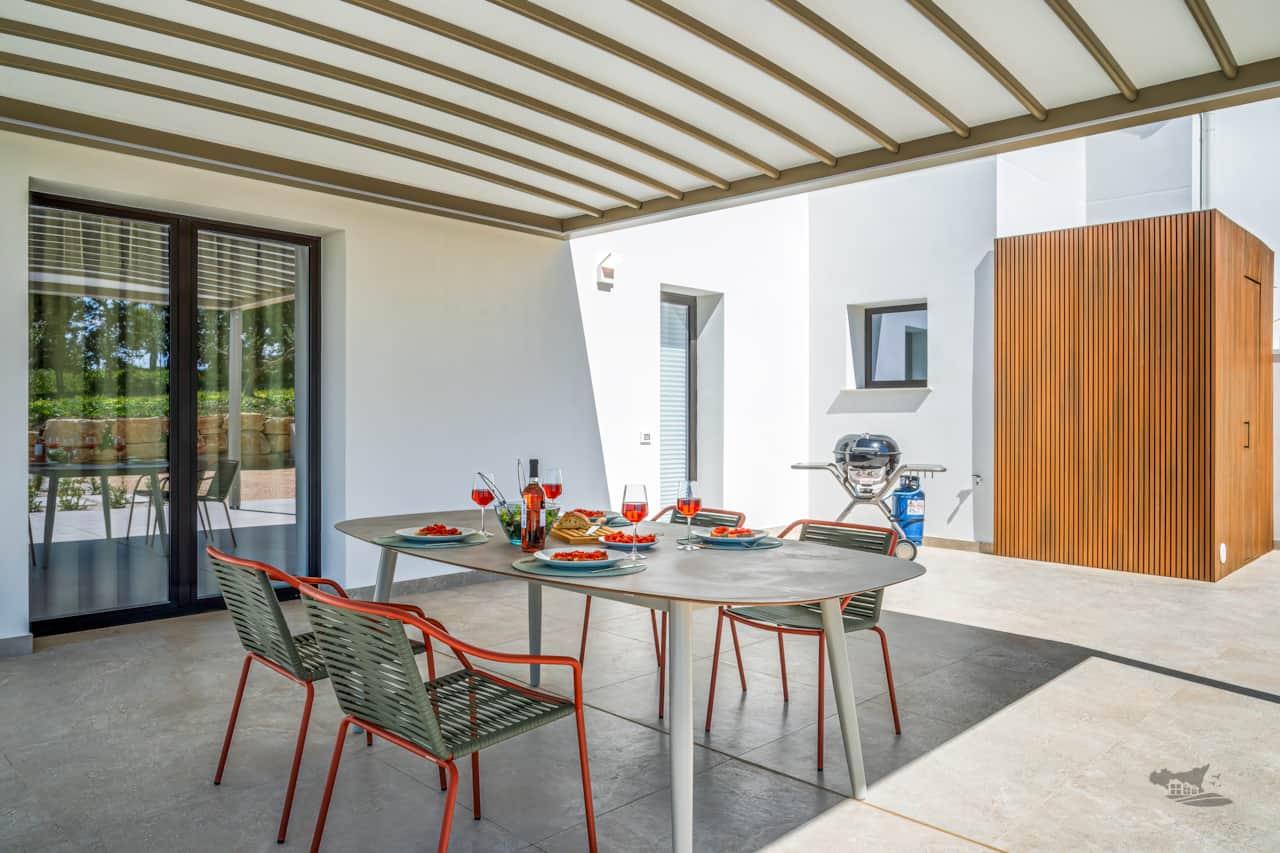 Enjoy delicious outdoor meals under the shade with a sleek BBQ just steps away.