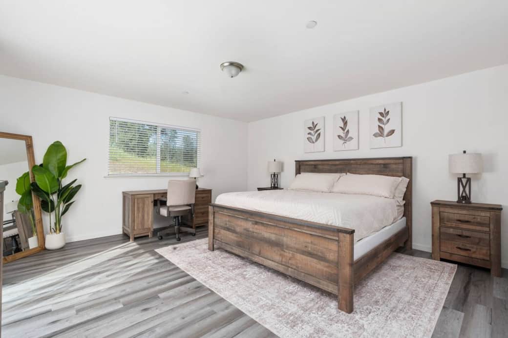 Spacious primary bedroom with a King bed, large mirror, and a dedicated workspace! Spacious primary bedroom with a King bed, large mirror, and a dedicated workspace!