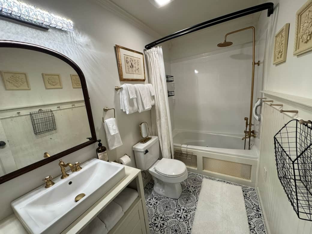Main bathroom features a spacious soak-in jetted tub and rain shower combo. It is fully stocked with plenty of towels, hair dryer and other essentials.  