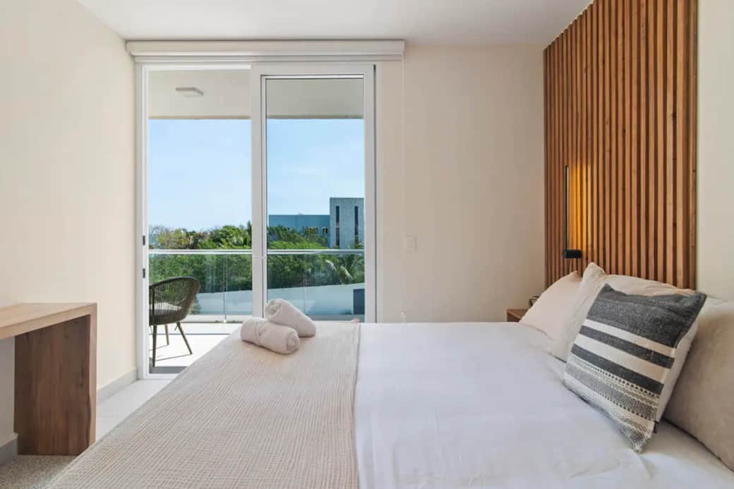 Bedroom's private balcony offers serene Caribbean sea breeze, perfect for coffee or wine.