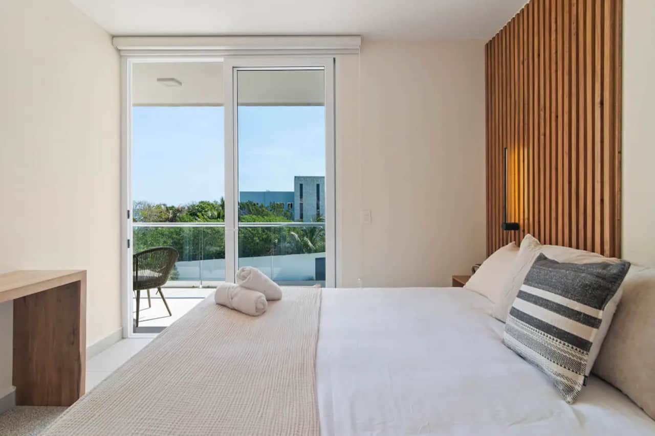 Bedroom's private balcony offers serene Caribbean sea breeze, perfect for coffee or wine.