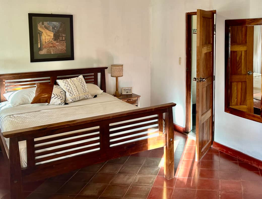 Queen bed and door to private bathroom Queen bed and door to private bathroom