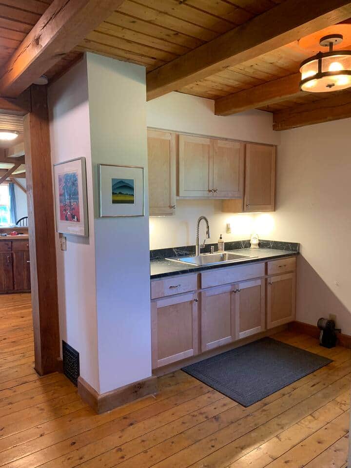 Mudroom with soapstone wash counter, cabinets and lockers also connects kitchen to entry door