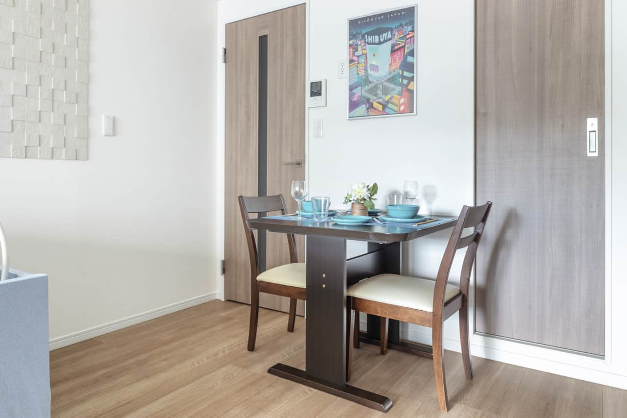 Dine in style with a charming two-person setup under colourful Tokyo artwork