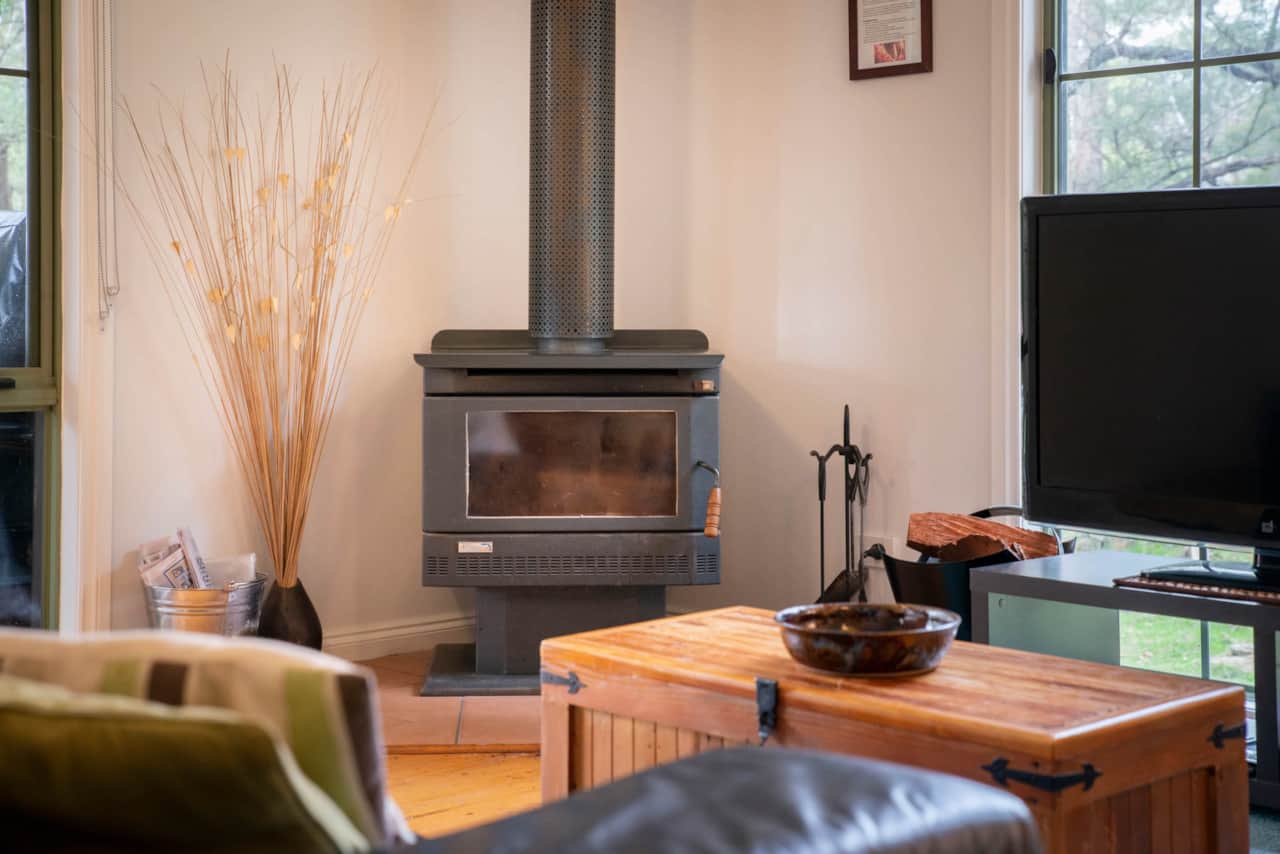 Unwind in the cozy living room by the wood fire for a delightful stay.