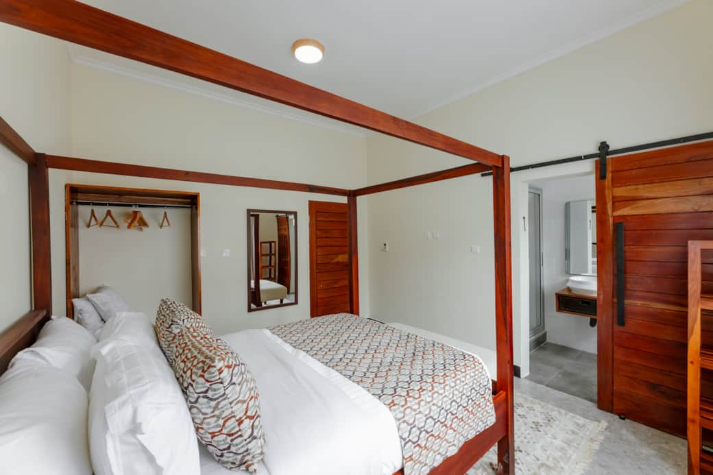 Spacious double bedroom with canopy bed, and natural light