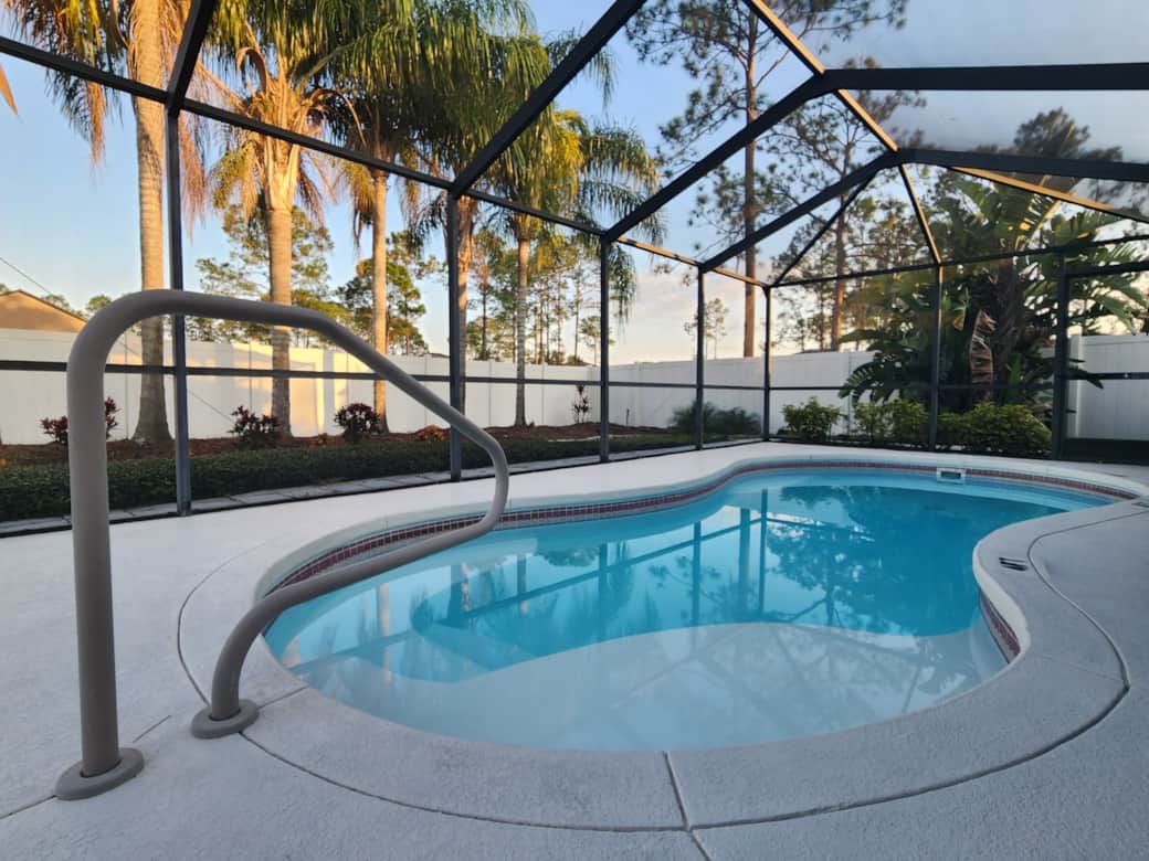 Heated Pool in Screened-In Lanai, Palm trees in backyard Heated Pool in Screened-In Lanai, Palm trees in backyard
