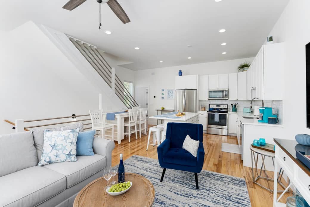 Bright, open living space with 10’ ceilings—perfect for gathering after beach days or movie nights together.