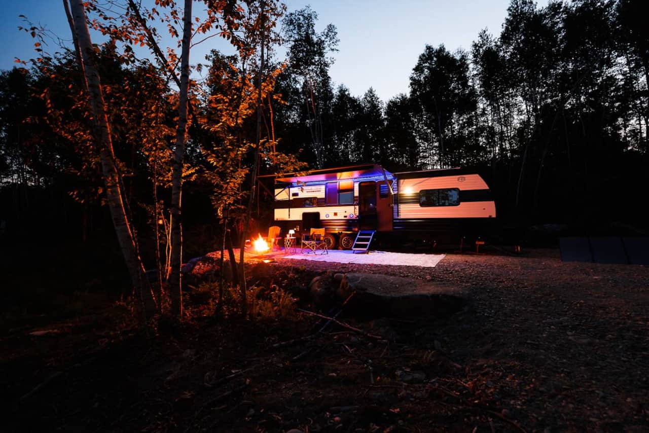 Front of the RV with sitting area and propane fire pit.