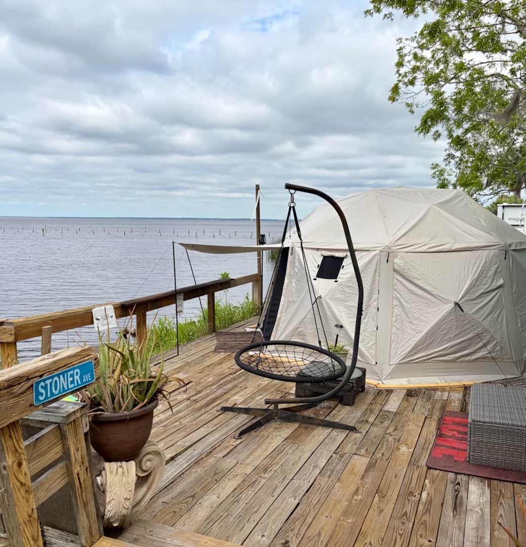 Sleep in and enjoy the serenity of our waterfront glamping yurt at Runaway Bay Lodge