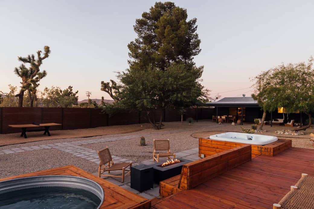 Backyard patio brings together the hot tub, cowboy pool and fire pit while enjoying the spacious backyard with beautiful desert trees and landscaping. Backyard patio brings together the hot tub, cowboy pool and fire pit while enjoying the spacious backyard with beautiful desert trees and landscaping.