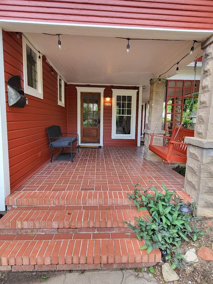Wonderful wrap around porch with a fire pit and seating to enjoy the peaceful neighborhood.