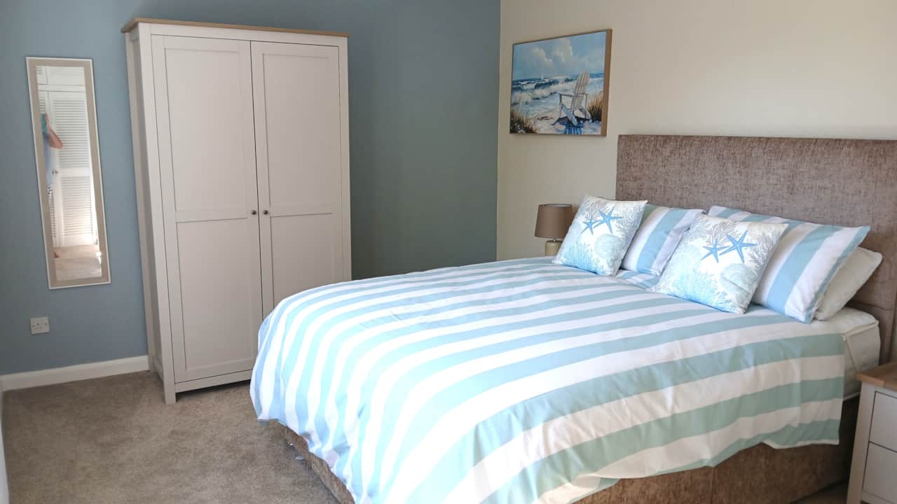 Beautifully furnished main bedroom with a comfortable king-size bed.