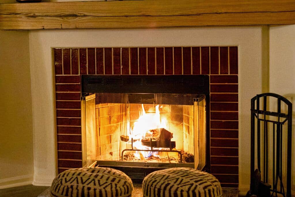 Get cozy around the fire in the wood burning fire place with the poufs. 
