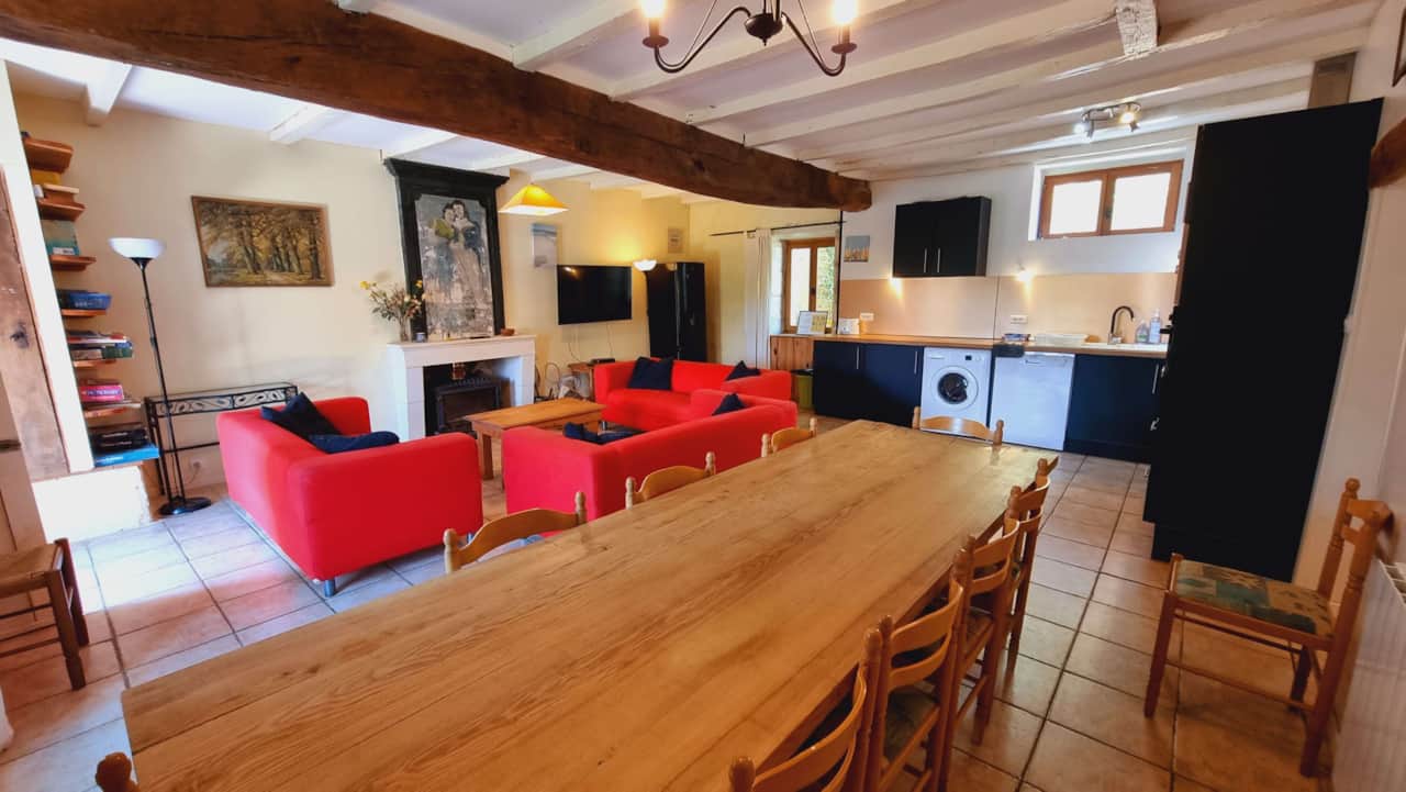 Spacious, colorful living room with exposed beams
