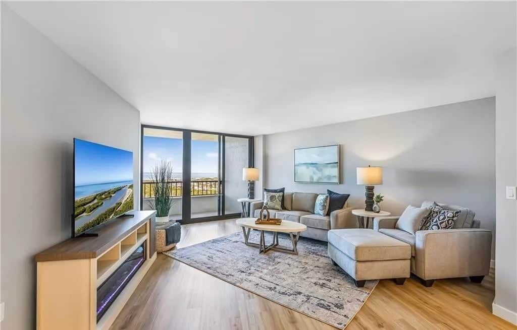 Bright, open living space with direct access to the private balcony and sweeping water views.