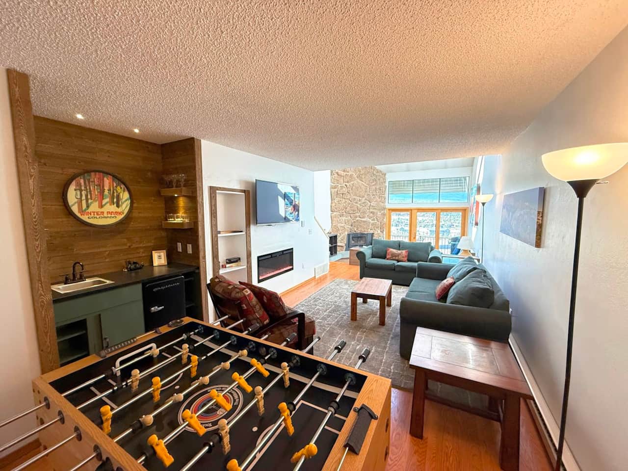 There is an electric fireplace in the TV area.