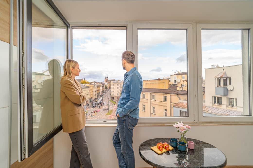 Przytulny kącik z dużymi oknami i widokiem na miasto.