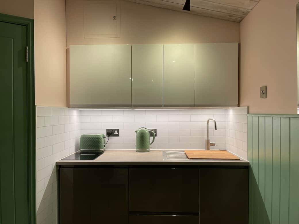 Kitchen with single hob, microwave, sink, toaster, kettle, cooking utensils, cutlery and crockery