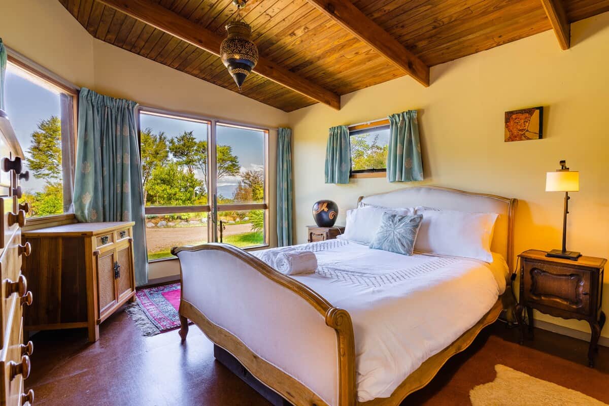 Lodge Master Bedroom with views across the petanque course and onto the Bay.