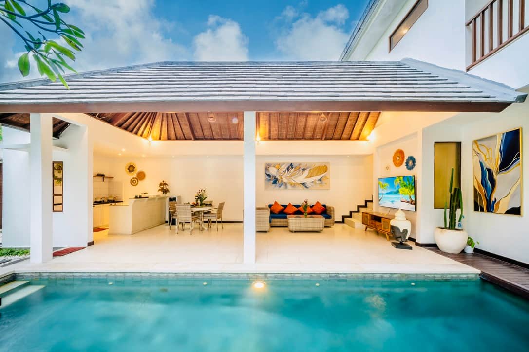 Open living area with pool access and tropical design