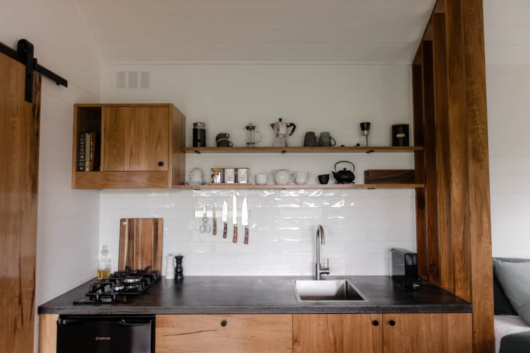 A fully equipped ktchenette with custom timber cabinetry and hand-poured concrete benchtop