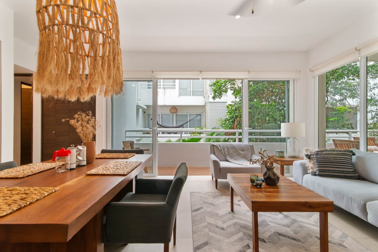 Relax in this cozy living room with balcony access, fresh air, and scenic views.