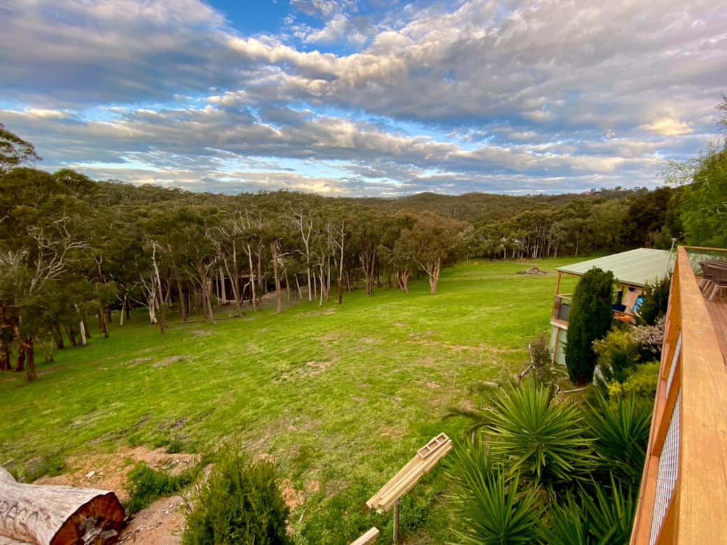 The view from the upstairs deck with the pool deck pergola in view on the right