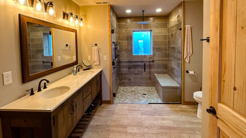 Luxury master bath featuring zero-entry shower with seamless floor transition