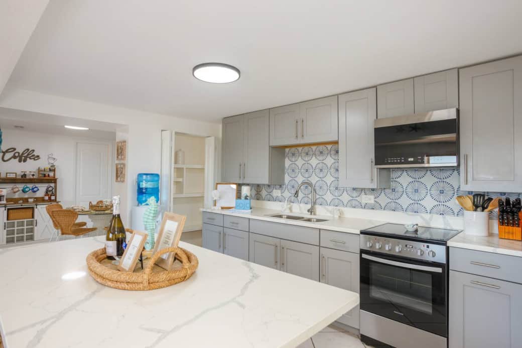 Spacious new kitchen featuring a marble island and sleek, updated appliances.