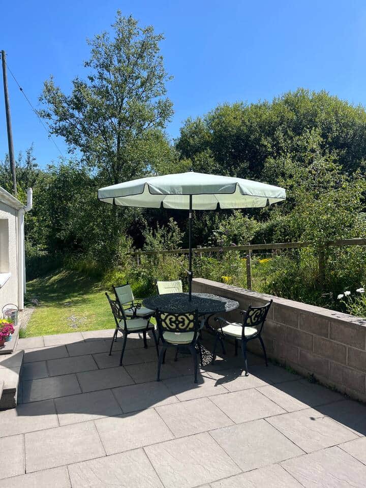 Patio with furniture. In good weather there will be a parasol and chair cushions.