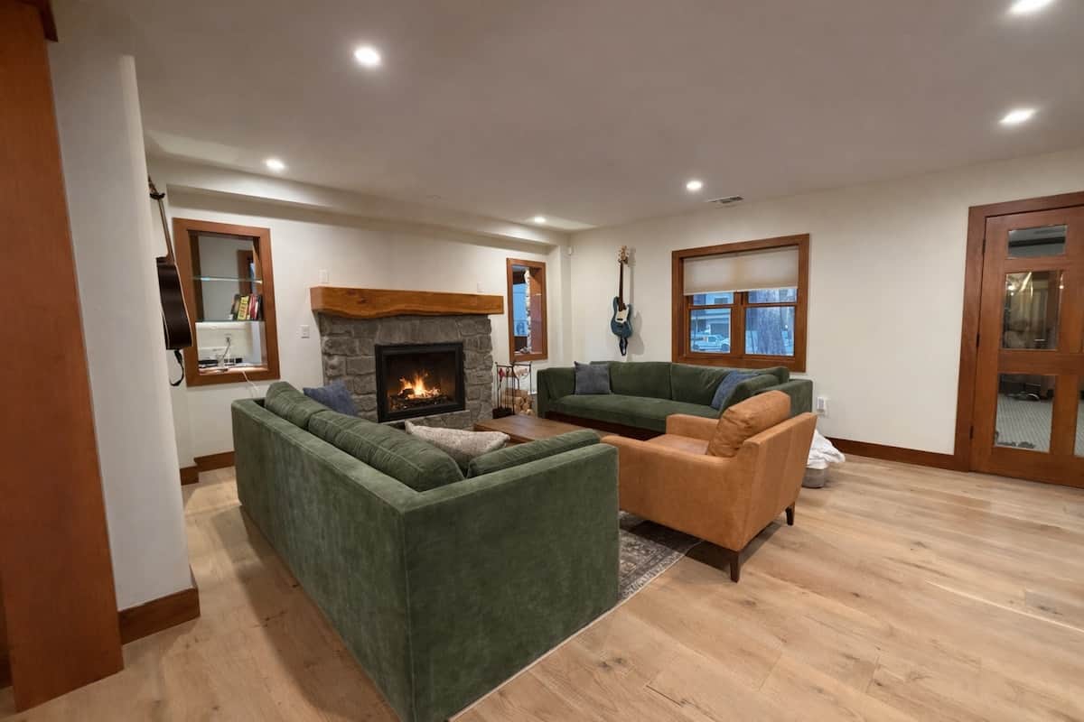 Cozy fireside lounge with stone wood-burning fireplace and queen murphy bed