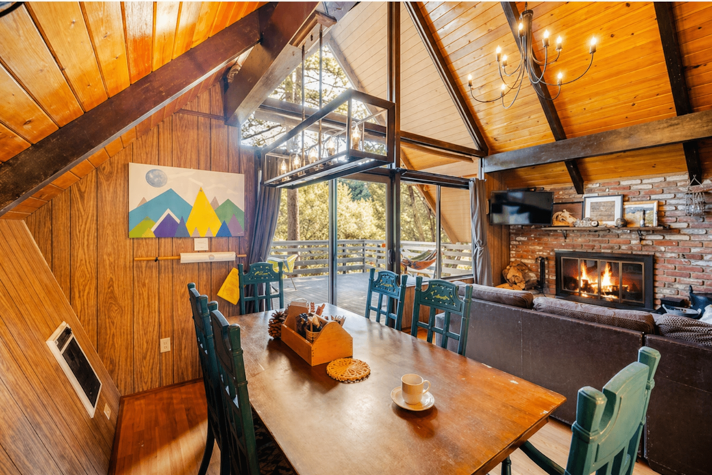Living Room with Soaring Two Story Windows and Wood Burning Fireplace