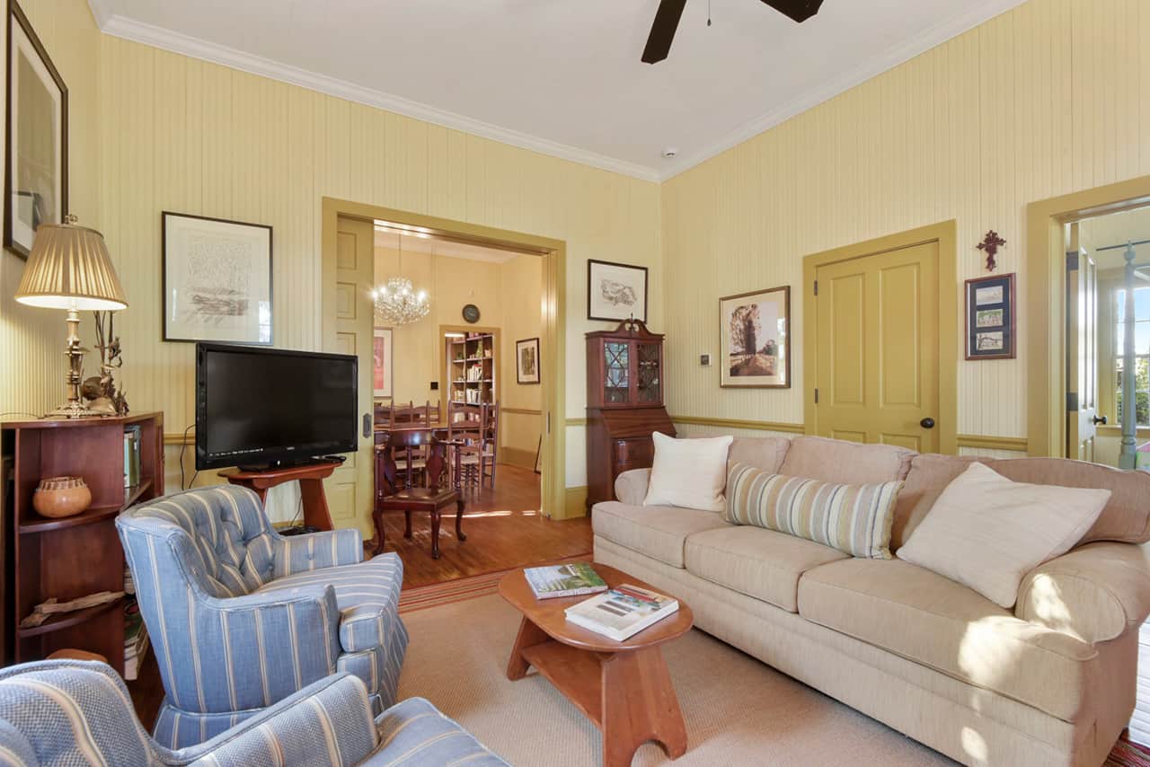 Living room has comfortable seating and a flat-screen TV. 