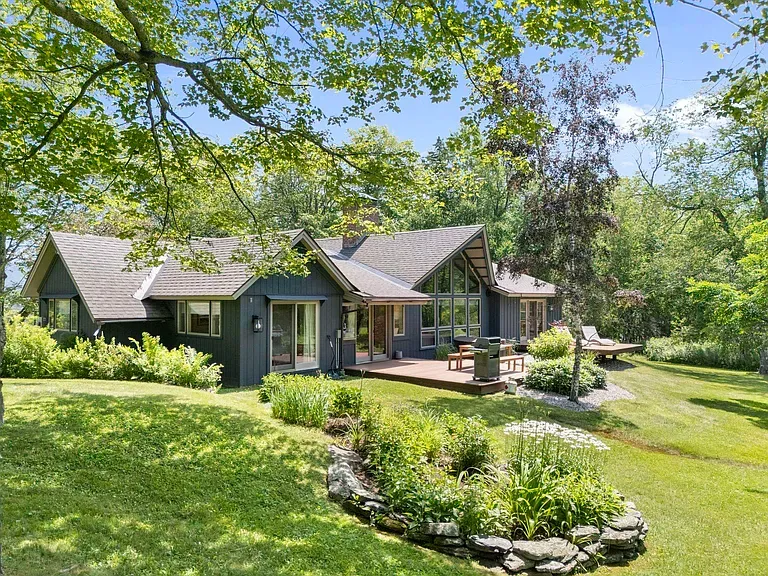 Exterior view — a modern mountain retreat surrounded by lush Vermont landscape and expansive grounds Exterior view — a modern mountain retreat surrounded by lush Vermont landscape and expansive grounds