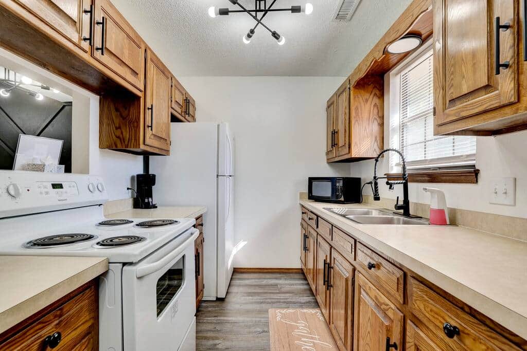 Full galley kitchen with electric range, microwave and full size fridge Full galley kitchen with electric range, microwave and full size fridge
