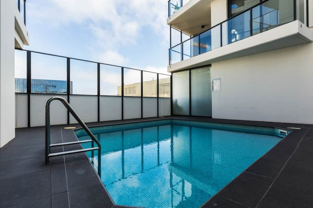 "Dive into luxury with our rooftop swimming pool, offering a refreshing escape from the city heat. The pool's design, complemented by the surrounding lounge area, provides an exclusive oasis for relaxation and leisure.
